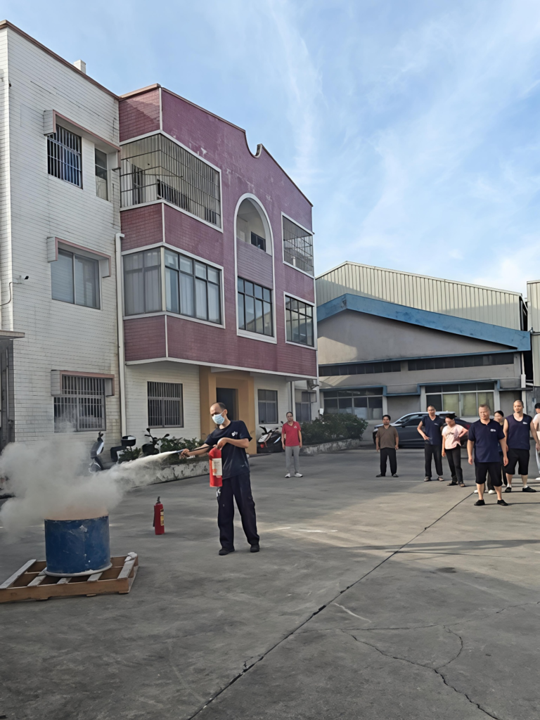 Employees practice using fire extinguishers